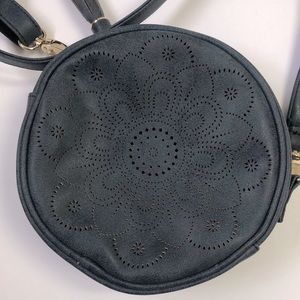 Small round blue crossbody bag.